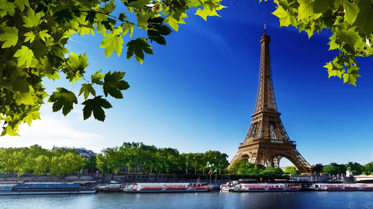 the eiffel tower framed by summer foliage on the banks of the seine, eiffel tower, france, cities, city, cityscape, cityscapes, landscapes, leaves, foliage, leafage, frondage, paris, parks, national parks, rivers, canals, streams, sky, trees, architecture, world