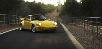a yellow porsche 911 on a forest road at dusk, 1993 porsche 911 carrera rs 3.8, cars, automobiles, discs, wheels, evening, evenings, twilight, dus, forest, forests, headlights, porsche, retro, roads, highways, motorways, avenues, driveways, passageways, sports cars, auto, vehicles