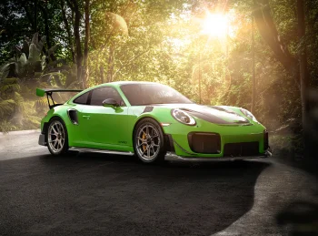 A bright green GT2 RS bathed in the morning sun amid tropical greenery