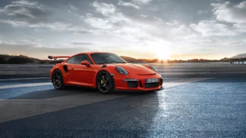 An orange Porsche 911 GT3 RS on the race track
