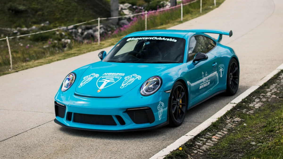 Яскраво-блакитний Porsche 911 GT3 на гірській дорозі