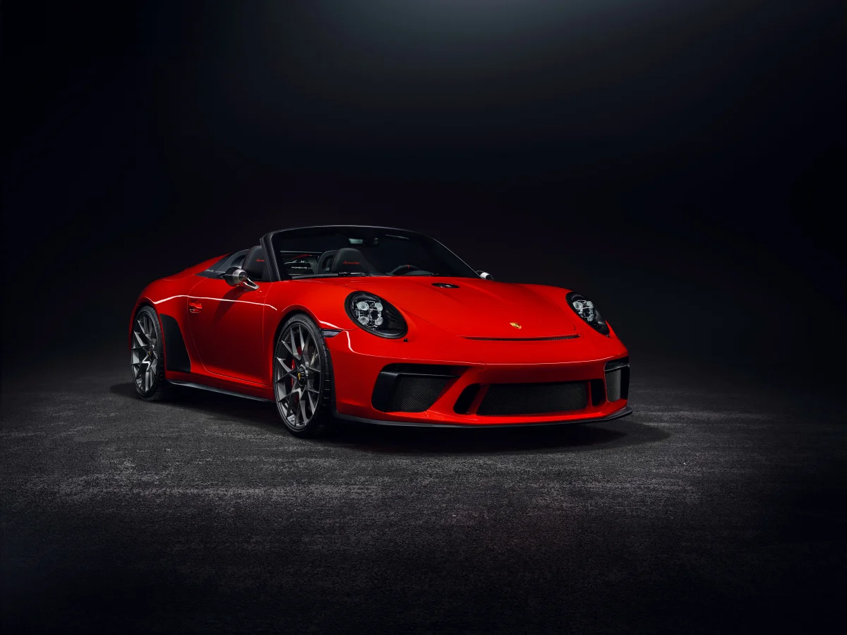A red Porsche 911 Speedster under studio lighting