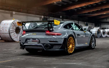 A gray Porsche 911 GT2 RS with gold wheels