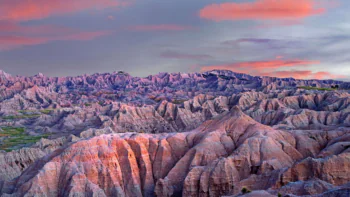 Pink hues of the sunset over Badlands National Park in the U.S.
