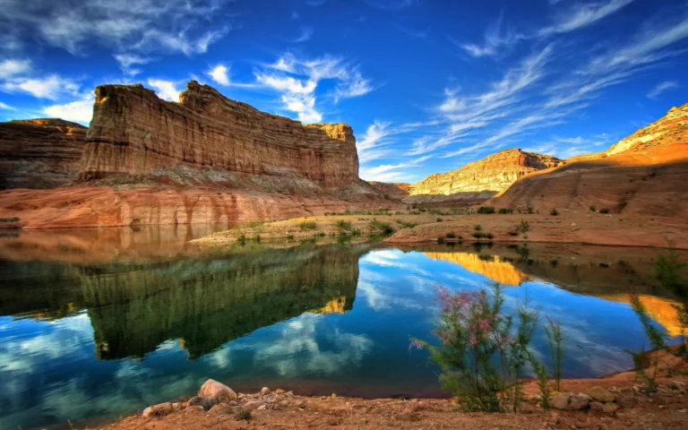 The reflection of the red cliffs in the lake's mirror-like surface