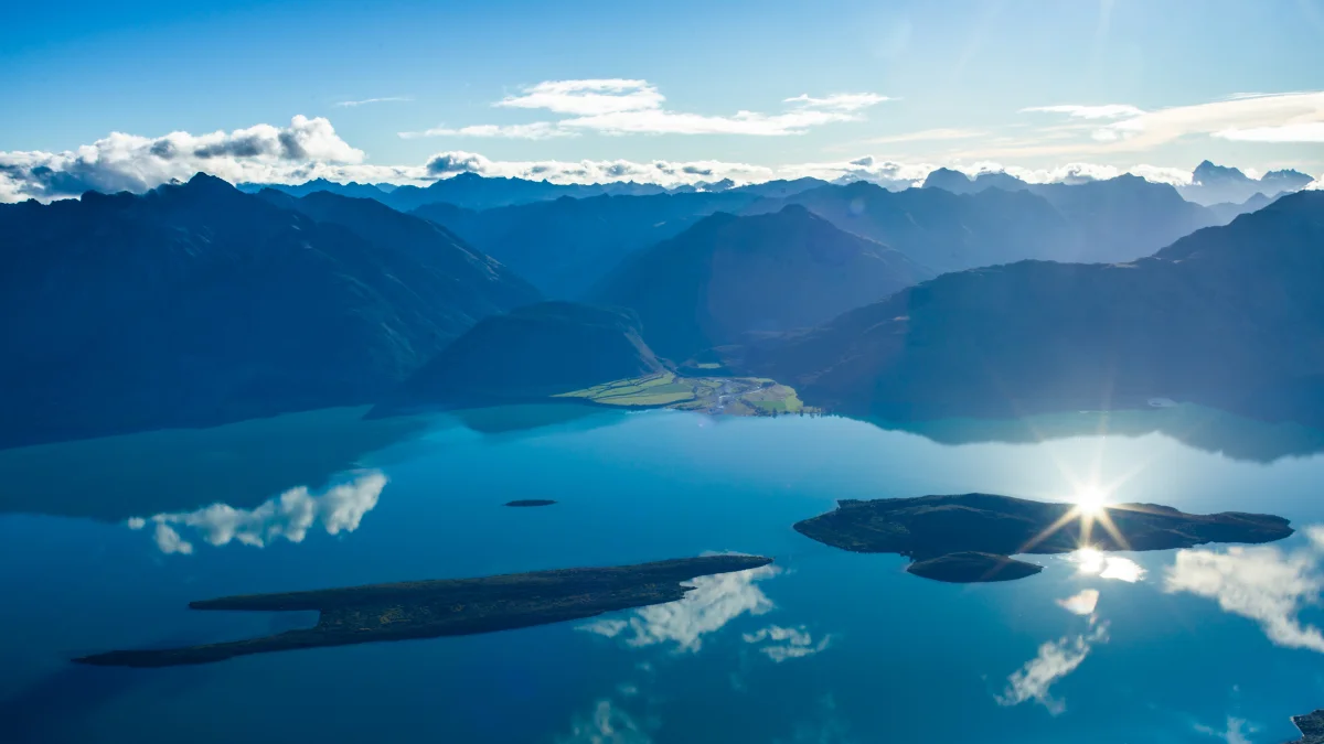 sun glints on the surface of lake wakatipu in new zealand, lake wakatipu, new zealand, clouds, islands, lakes, bodies of water, landscapes, mountains, peaks, hills, reflections, sky, nature, world