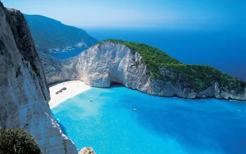 the turquoise waters of navajo bay on the greek island of zakynthos, navajo bay, greece, beaches, coasts, boats, motorboats, speedboats, cliffs, islands, landscapes, mountains, peaks, hills, sea, ships, vessels, summer, nature, world