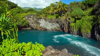 a tropical lagoon surrounded by rocks and lush greenery, cliffs, lagoons, lakes, bodies of water, landscapes, palm trees, nature, world