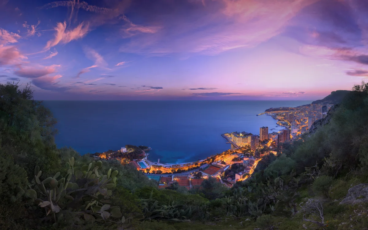 Monaco's evening lights against a lilac sky