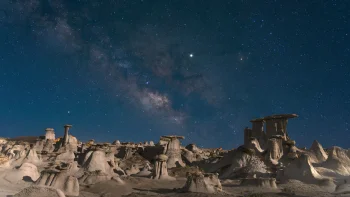 The Milky Way over rock formations in the desert