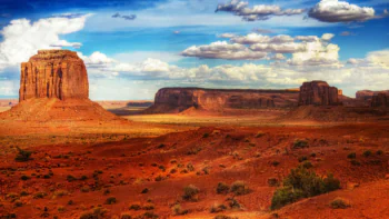 The red cliffs of Monument Valley under a cloudy sky in the U.S.