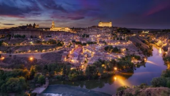 The lights of Toledo at night against the backdrop of the twilight Spanish sky