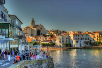 The evening waterfront in Cadaqués, with its white houses and the Church of Santa María