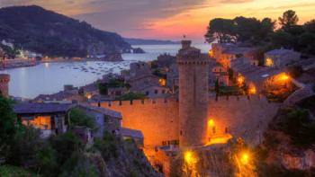 Sunset over the fortress walls of Tossa de Mar in Spain