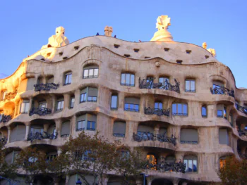 The facade of the Mila building bathed in the rays of the setting sun in Barcelona