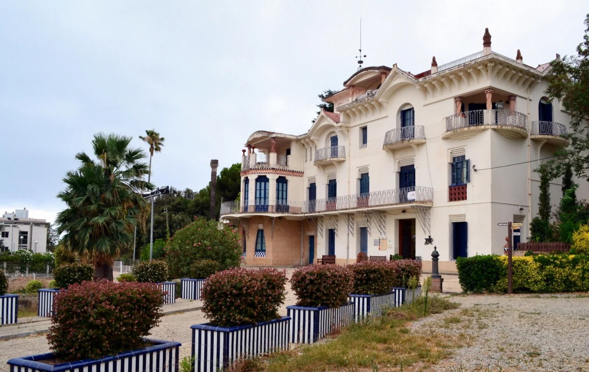 An old villa in a small Spanish town under a cloudy sky