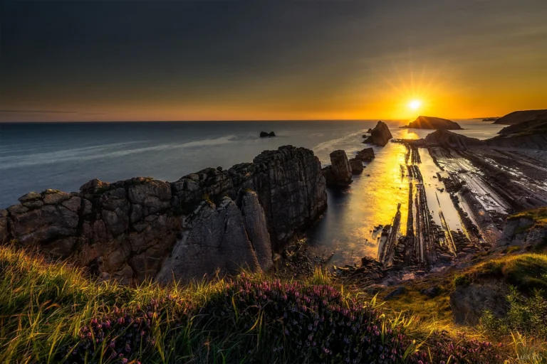 A golden sunset over Spain's rocky coastline