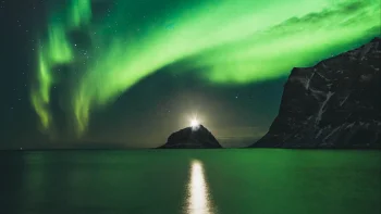 A green glow over a rocky island in Norway