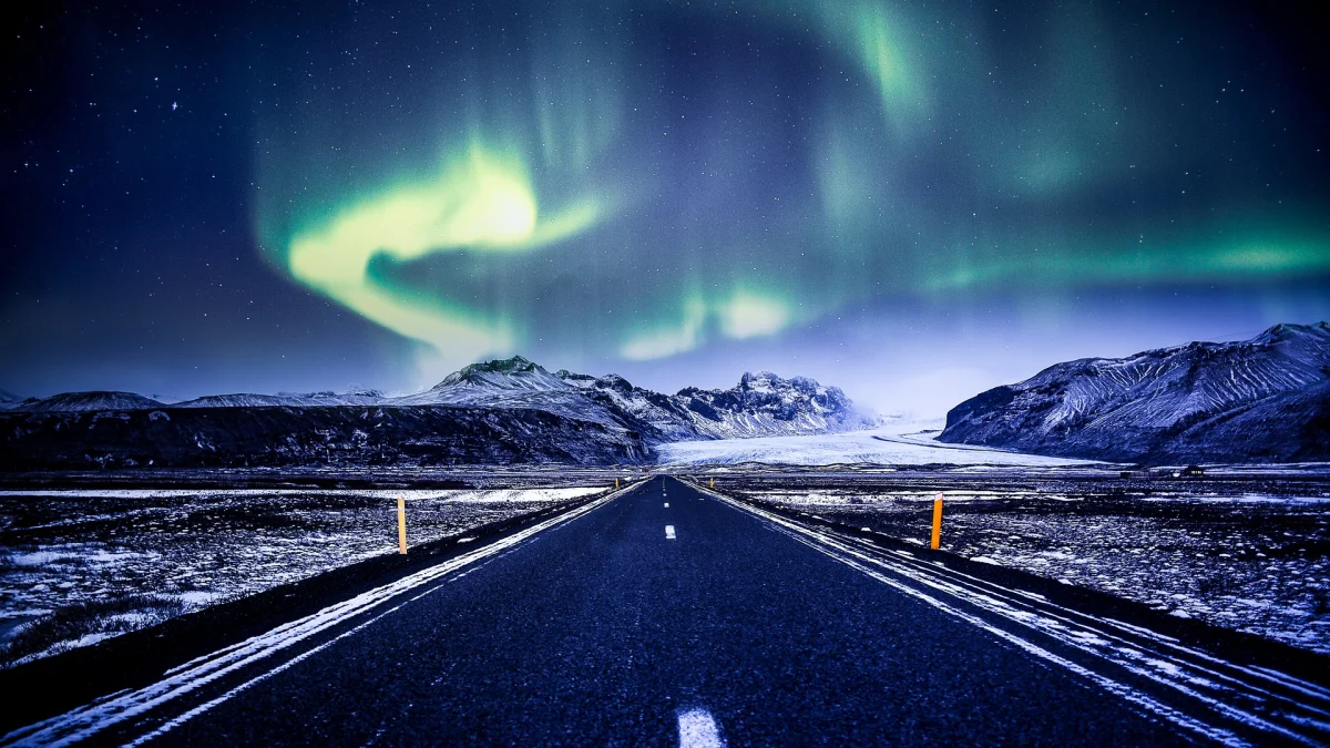 A deserted road amid the snow-capped mountains of Iceland