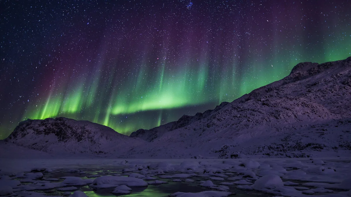 Green flashes above the snow-capped mountains