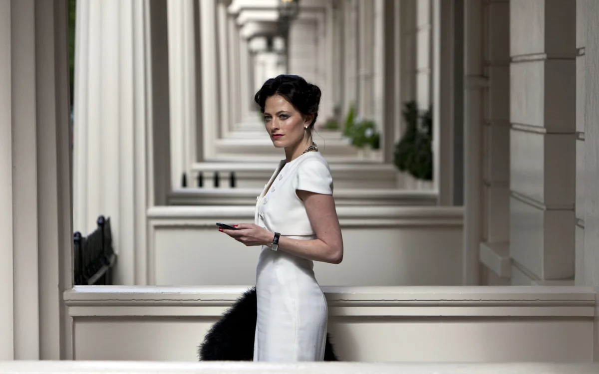 Lara Pulver in the hallway of a classic mansion