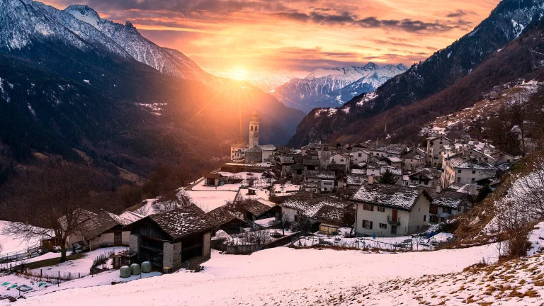 the village of solio in switzerland, alps, churches, houses, buildings, landscapes, mountains, peaks, hills, snow, sun, sun rays, sunlight, rays, sunsets, sunset, switzerland, valleys, villages, settlements, winter, winters, nature, world