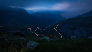 the winding road of the st. gotthard pass in switzerland, st. gotthard pass, alps, clouds, evening, evenings, twilight, dus, hairpin turns, landscapes, mountains, peaks, hills, night lights, lights, streetlights, street lamps, lighting, night, roads, highways, motorways, avenues, driveways, passageways, switzerland, valleys, nature, world