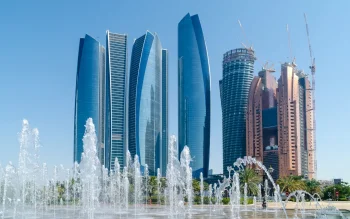 The glass towers of Etihad Towers against the backdrop of a clear sky in Abu Dhabi