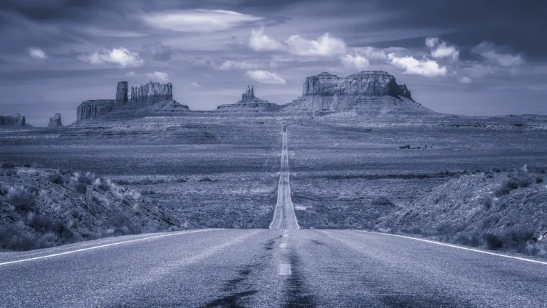The endless road to the cliffs of the Valley of Monuments at dusk