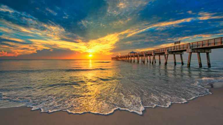 A golden sunset over a pier in Florida