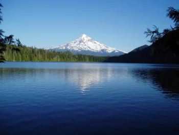 The reflection of the snow-capped peak of Mount Hood in the waters of Lost Lake