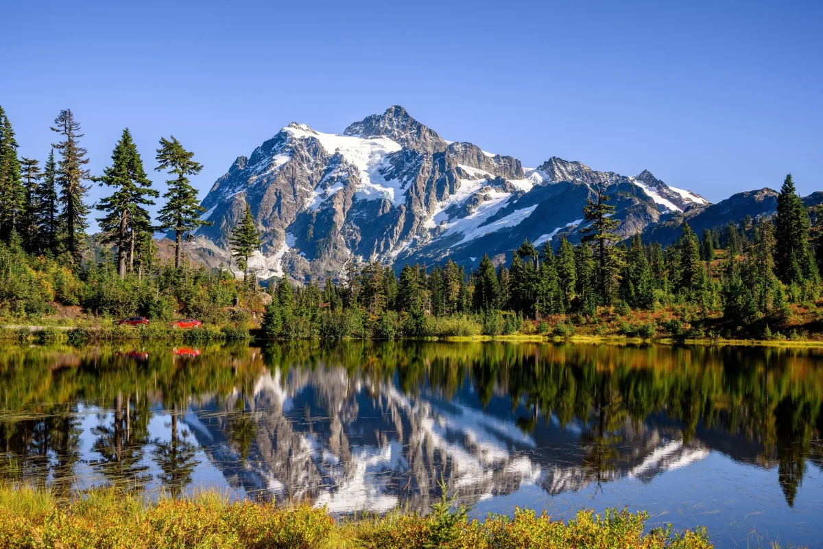 The reflection of the snow-capped Shuksan Peak in the waters of Old Back Lake in Washington State