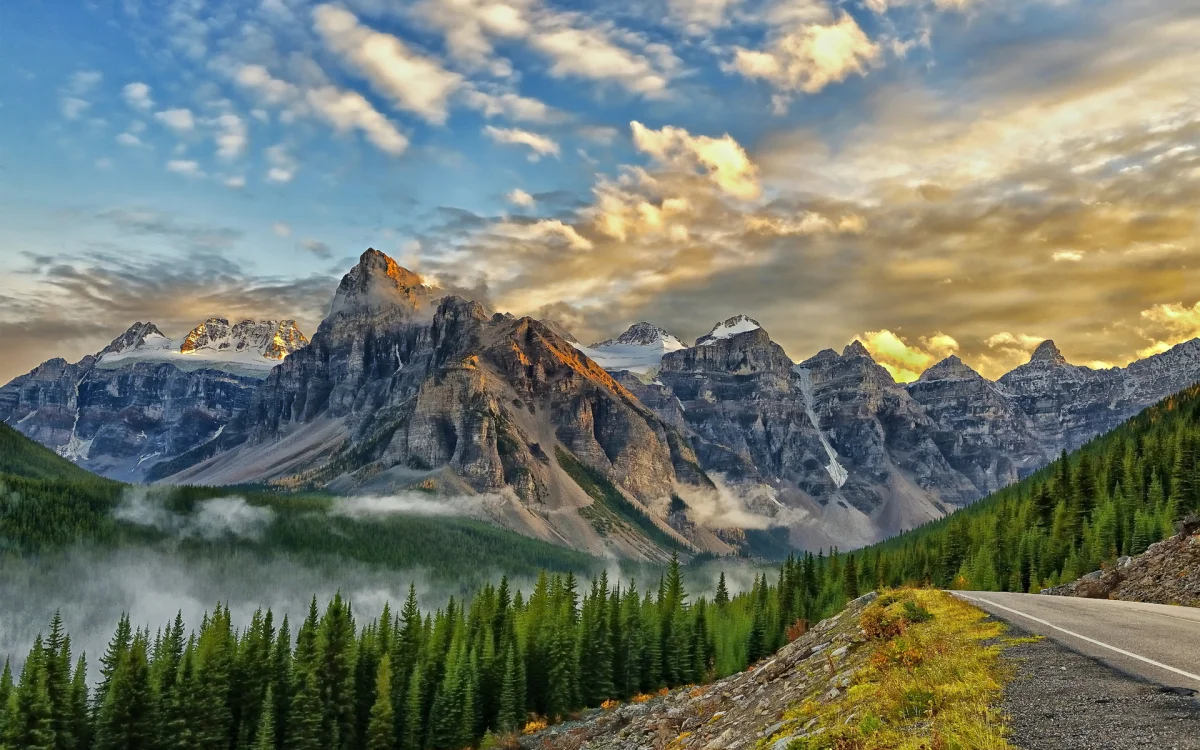 The golden light of sunset over the Canadian mountains and coniferous forest