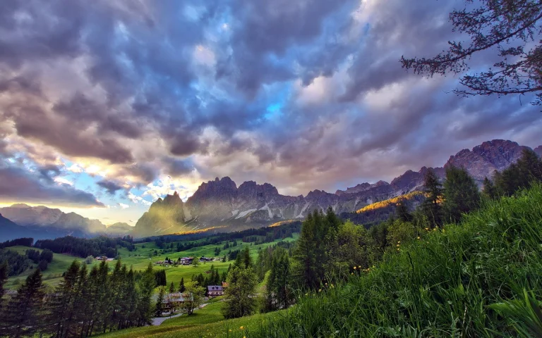 Golden rays of sunlight over the alpine meadows of the Dolomites