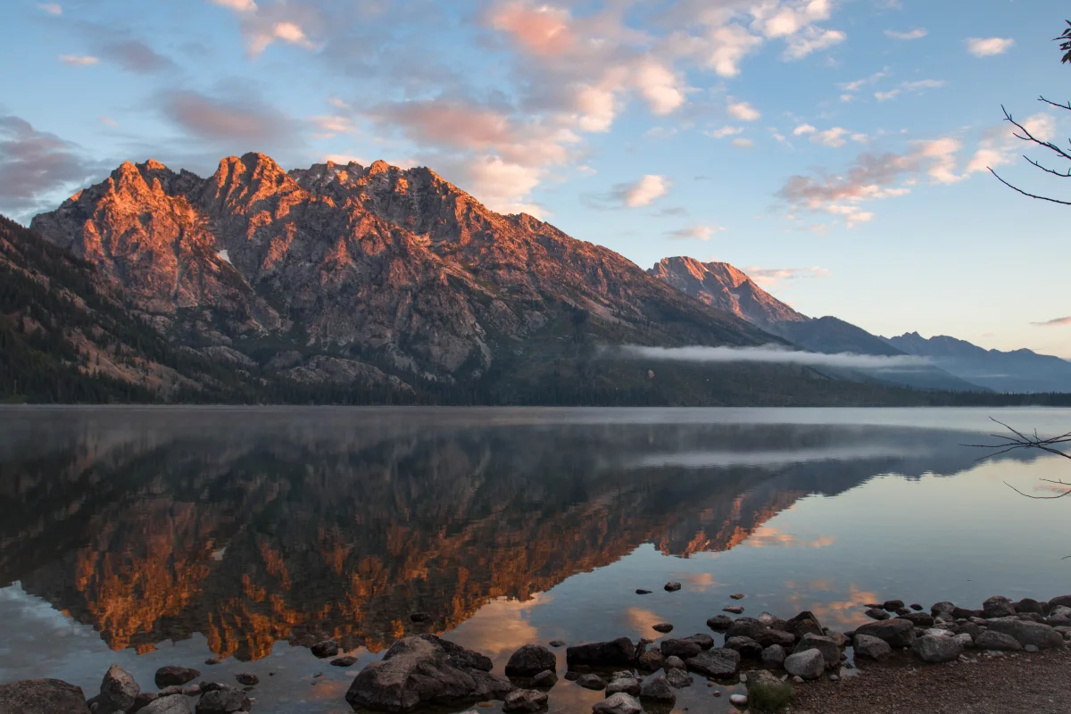 The golden light of sunset on the peaks of the Grand Teton Range in the United States