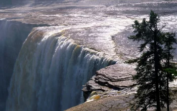 streams of water at the edge of a rocky cliff, churchill, canada, cliffs, landscapes, rivers, canals, streams, stones, sun, sun rays, sunlight, rays, trees, waterfalls, nature