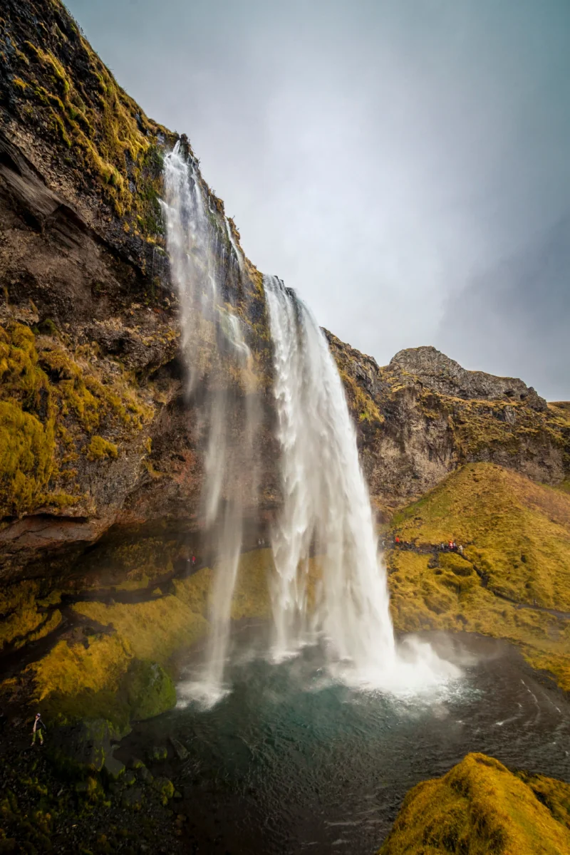 Seljalandsfoss Waterfall in Iceland under a cloudy sky