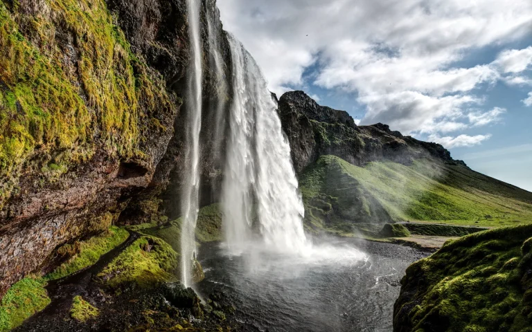 The waters of Seljalandsfoss in an Icelandic valley