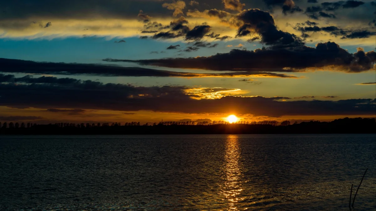 A golden glow over the calm surface of the lake
