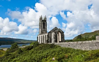 The ruins of Gollan Church in Ireland, set against a backdrop of hills