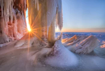 golden rays of sunlight in the ice caves of lake verkhnee, caves, ice, ices, icicles, lakes, bodies of water, snow, sun, sun rays, sunlight, rays, sunsets, sunset, winter, winters, nature