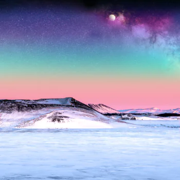 The Milky Way over the snow-capped mountains of Iceland