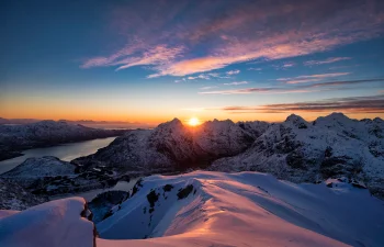 the first rays of the sun over norway's snow-capped peaks, bays, coves, straits, fjords, landscapes, morning, mountains, peaks, hills, sky, snow, sun, sun rays, sunlight, rays, sunrises, dawn, winter, winters, nature