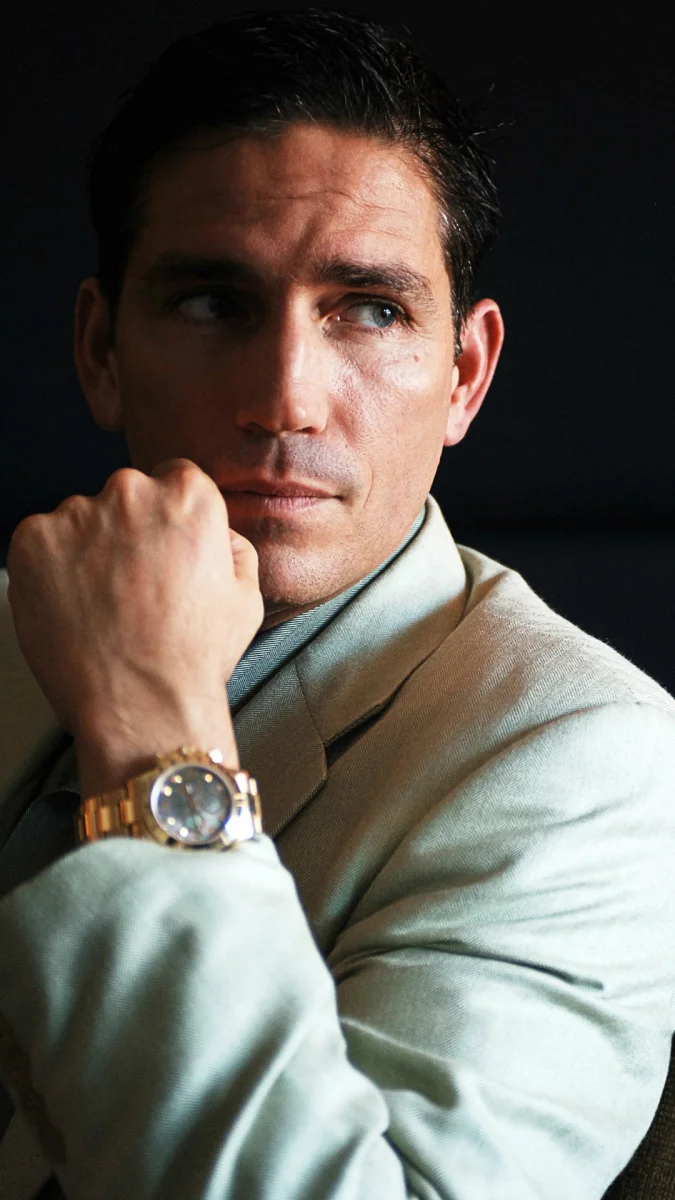 James Caviezel in a light-colored jacket with a gold watch