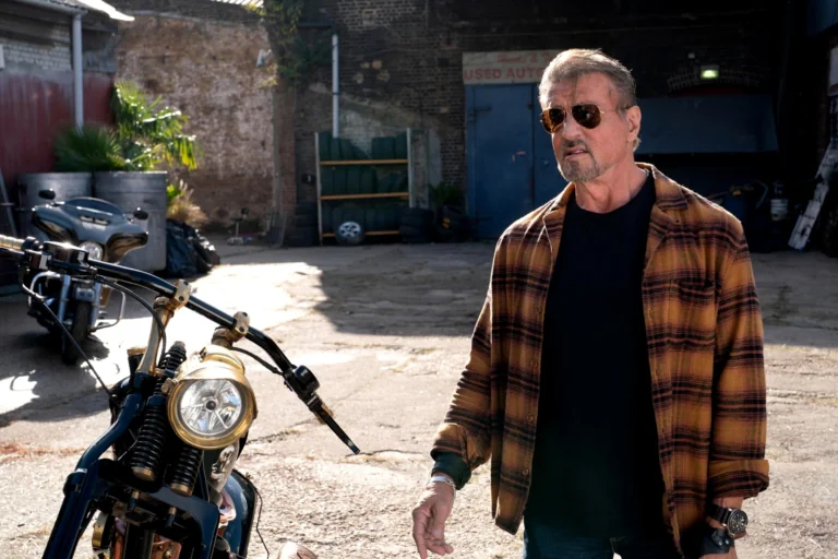 Sylvester Stallone in character, with motorcycles in the background
