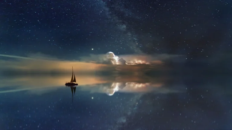 A lone sailboat beneath the Milky Way