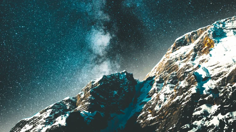 The Milky Way above the snow-capped mountain peaks