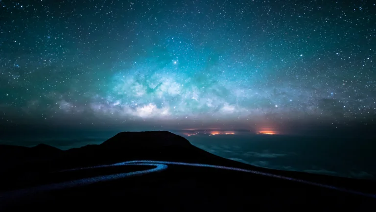 The Milky Way above the dark silhouette of a mountain range