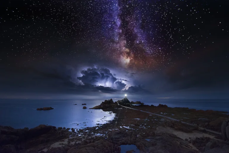 The La Corbière Lighthouse on the island of Jersey under stormy skies