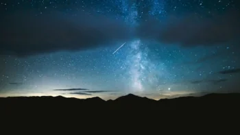 The Milky Way above the dark silhouettes of the mountains